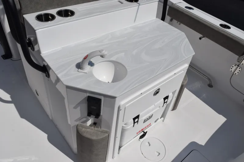 Slide: The Image of 2026 Sea Hunt Ultra 275 SE boat interior with sink and storage area. - 9