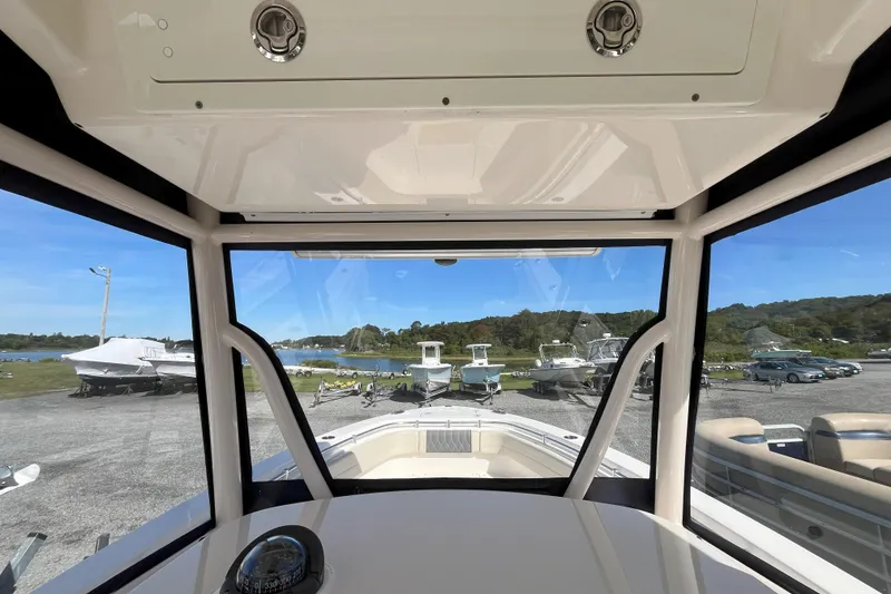 Slide: The Image of Interior view from a 2019 Cobia 277 Center Console boat, overlooking a marina. - 10