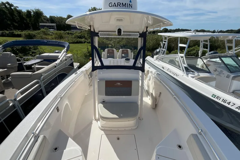 Slide: The Image of 2019 Cobia 277 Center Console boat with Garmin equipment, docked alongside other boats. - 13