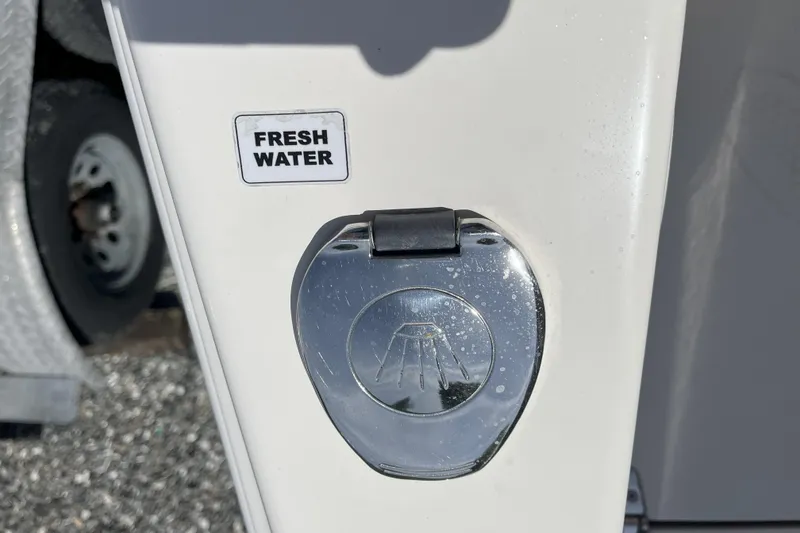 Slide: The Image of 2019 Cobia 277 Center Console fresh water access panel. - 15