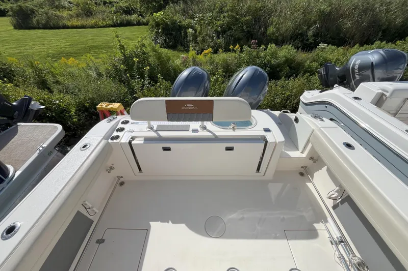 Slide: The Image of 2019 Cobia 277 Center Console boat with dual engines, viewed from the deck. - 6
