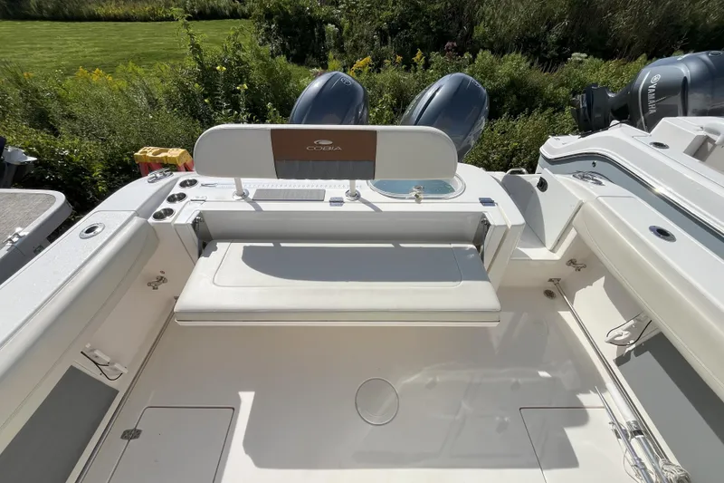 Slide: The Image of 2019 Cobia 277 Center Console boat interior with seating and dual engines. - 7