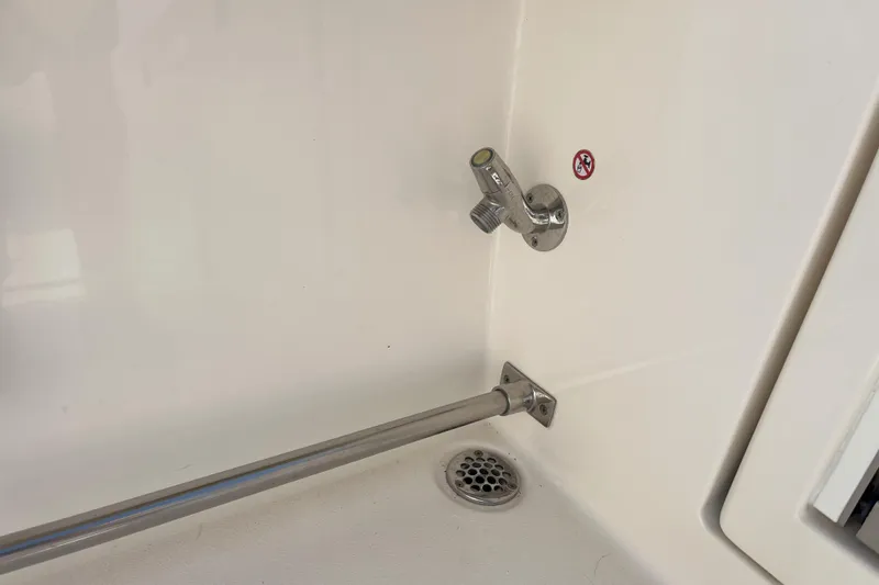 Slide: The Image of 2019 Cobia 277 Center Console boat interior with faucet and drain detail. - 9