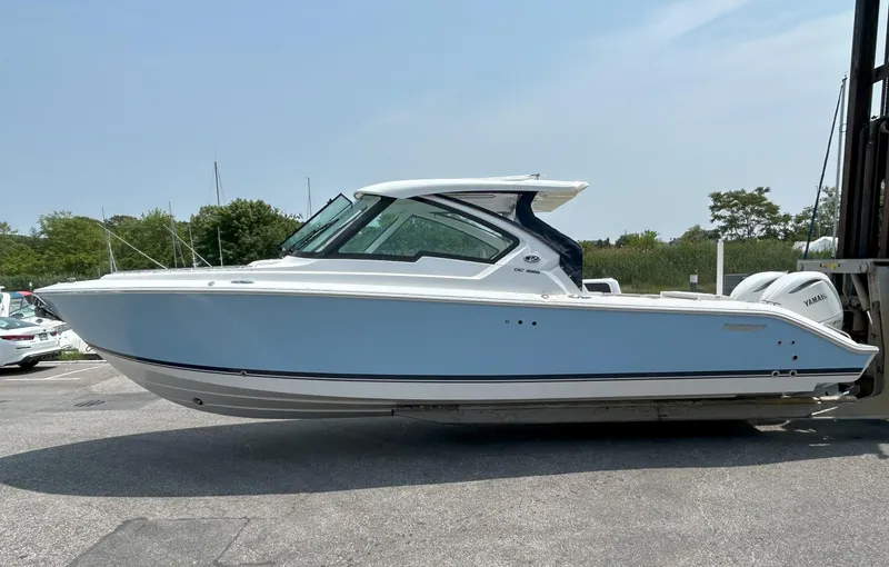 The Image of 2026 Pursuit DC 326 boat on display in a marina setting. - 0