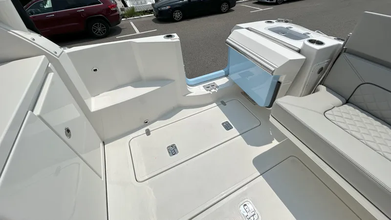 Slide: The Image of 2026 Pursuit DC 326 boat interior with seating and storage compartments. - 10