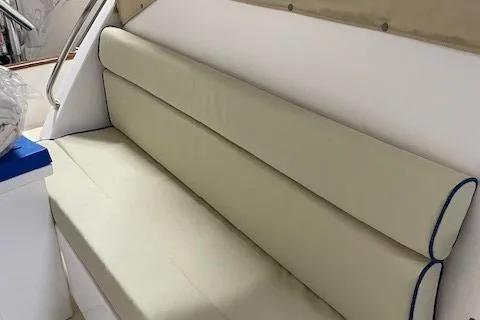 Slide: The Image of 2003 Legacy Yachts 34 Express interior with beige cushioned seating. - 12