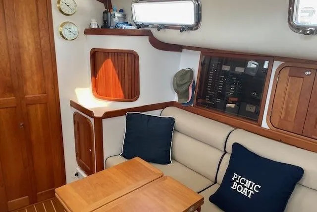 Slide: The Image of Interior of 2003 Legacy Yachts 34 Express with cozy seating and nautical decor. - 18