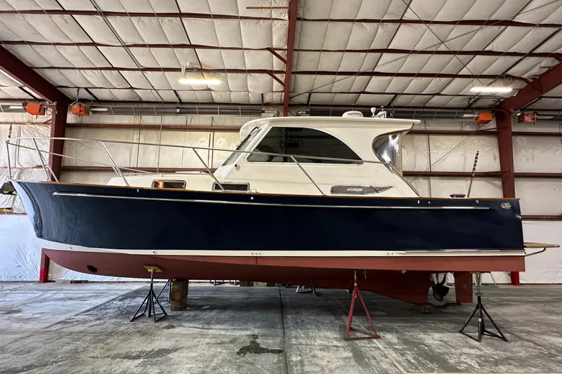 Slide: The Image of 2003 Legacy Yachts 34 Express in a warehouse, side view. - 2