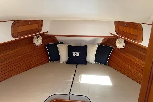 Slide: The Image of 2003 Legacy Yachts 34 Express cabin with cozy bedding and wooden accents. - 23