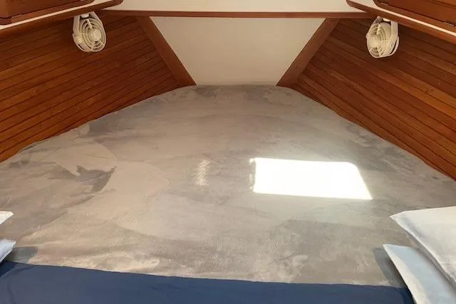 Slide: The Image of Cozy interior cabin of 2003 Legacy Yachts 34 Express with wooden paneling and soft lighting. - 25