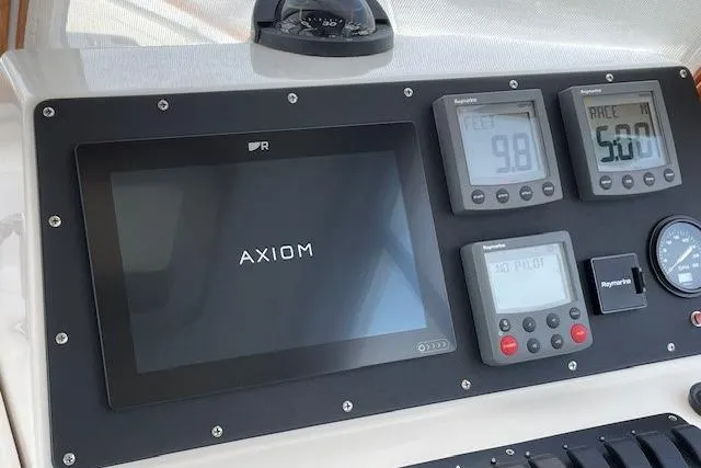 Slide: The Image of Control panel of 2003 Legacy Yachts 34 Express with Axiom display and Raymarine instruments. - 26