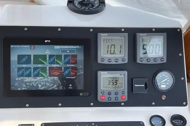 Slide: The Image of Control panel of 2003 Legacy Yachts 34 Express with navigation and depth displays. - 27
