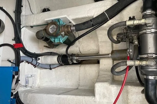 Slide: The Image of Engine compartment of 2003 Legacy Yachts 34 Express, showing mechanical components and wiring. - 33