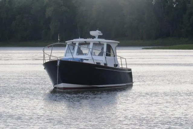 Slide: The Image of 2003 Legacy Yachts 34 Express cruising on calm waters. - 38