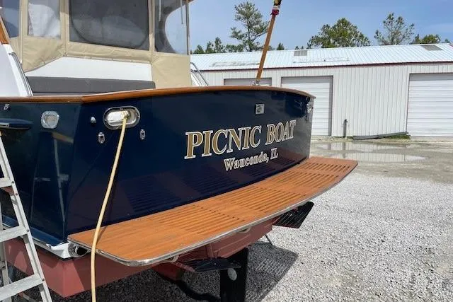 Slide: The Image of 2003 Legacy Yachts 34 Express boat with "Picnic Boat" name, docked outdoors. - 39