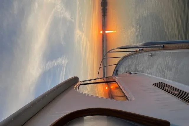 Slide: The Image of 2003 Legacy Yachts 34 Express at sunset on calm waters. - 44