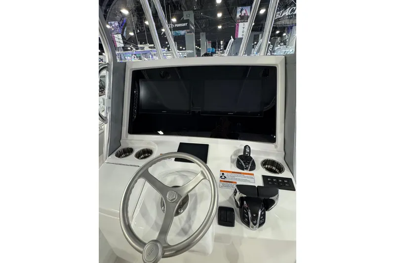Slide: The Image of 2026 Contender 35 ST boat dashboard with steering wheel and control panel. - 17
