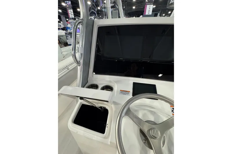 Slide: The Image of Center console of 2026 Contender 35 ST boat with steering wheel and cup holders. - 18