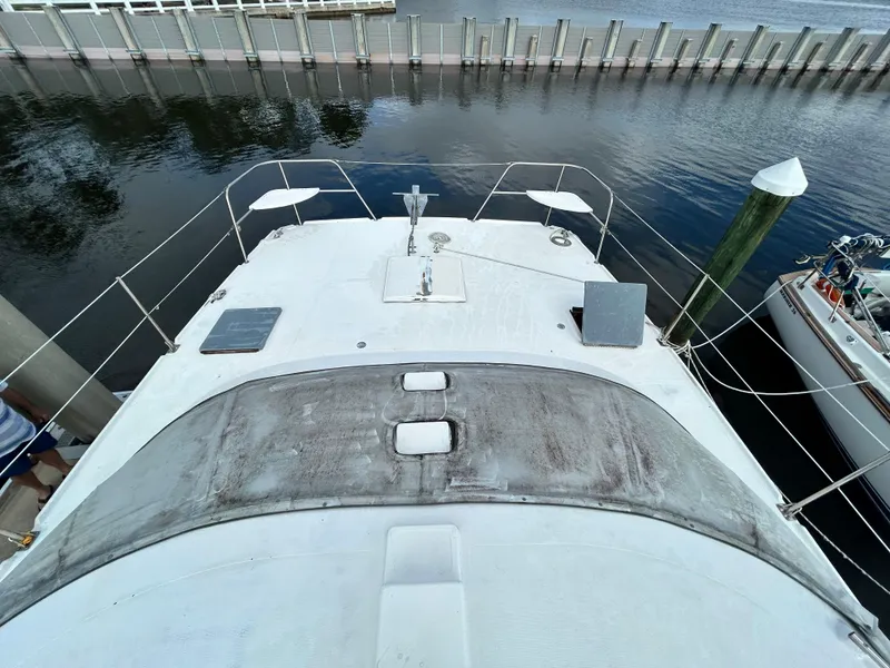 Slide: The Image of 2004 Endeavour Catamaran Victory docked, top deck view with water and pier background. - 10