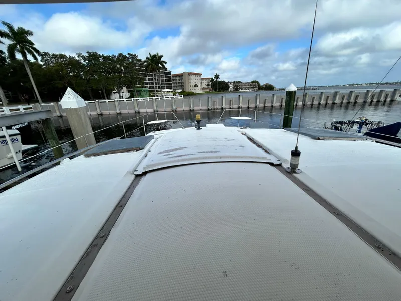 Slide: The Image of 2004 Endeavour Catamaran Victory docked at a marina with a scenic waterfront view. - 17