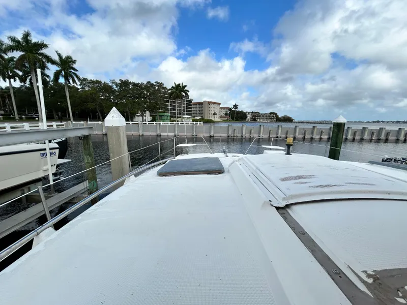 Slide: The Image of 2004 Endeavour Catamaran Victory docked at a marina with palm trees and buildings in the background. - 19
