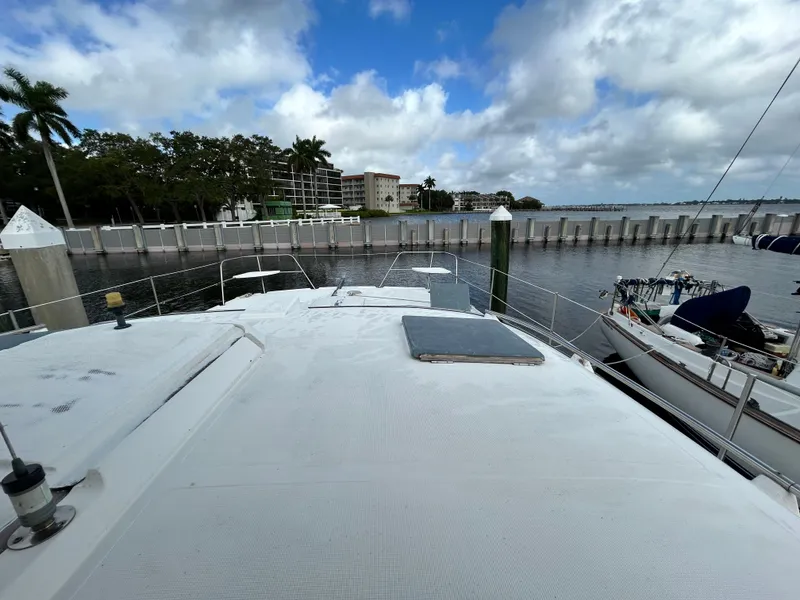 Slide: The Image of 2004 Endeavour Catamaran Victory docked at marina with scenic waterfront view. - 20