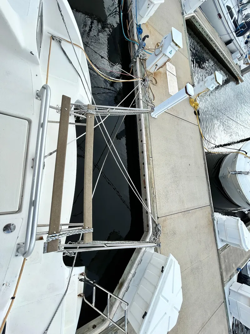 Slide: The Image of 2004 Endeavour Catamaran Victory docked at marina, view of stern and boarding ladder. - 26