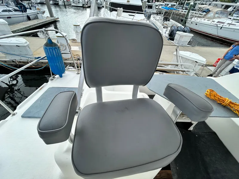 Slide: The Image of Captain's chair on a 2004 Endeavour Catamaran Victory at a marina. - 37