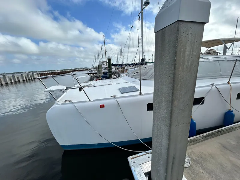 Slide: The Image of 2004 Endeavour Catamaran Victory docked at marina with clear skies. - 4