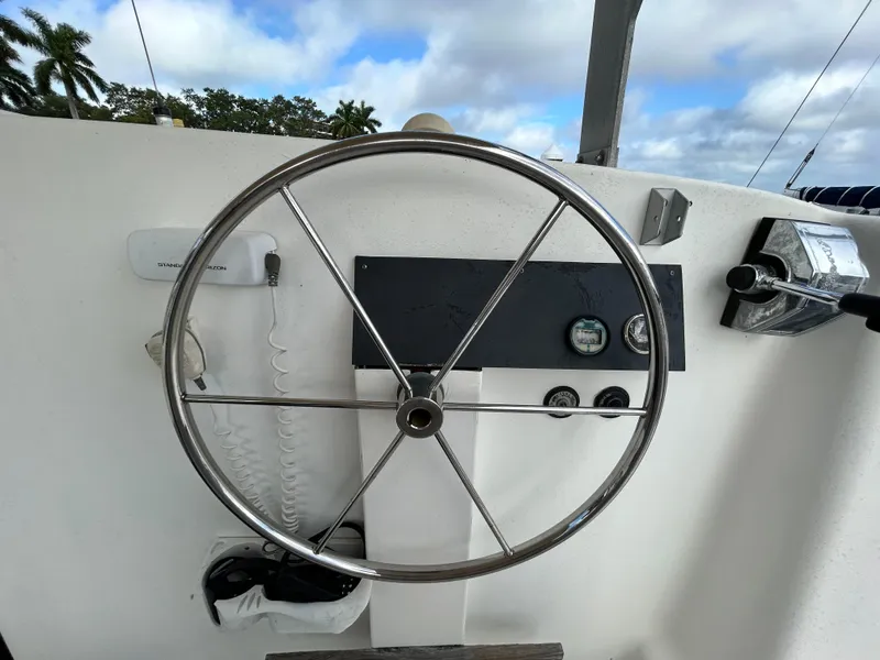 Slide: The Image of Steering wheel and control panel of a 2004 Endeavour Catamaran Victory. - 42