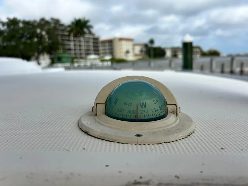 Slide: The Image of Compass on 2004 Endeavour Catamaran Victory, docked near waterfront buildings. - 46