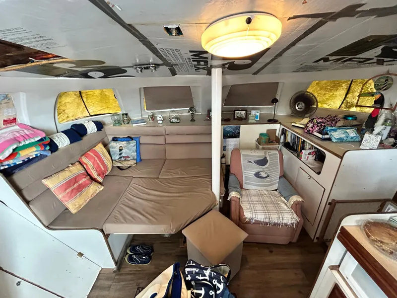 Slide: The Image of Interior of 2004 Endeavour Catamaran Victory with cozy seating and nautical decor. - 48