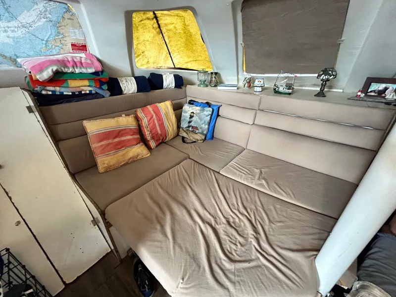 Slide: The Image of Interior seating area of a 2004 Endeavour Catamaran Victory with cushions and nautical decor. - 49