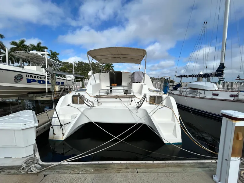 Slide: The Image of 2004 Endeavour Catamaran Victory docked at marina with clear sky background. - 6