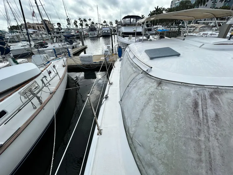 Slide: The Image of 2004 Endeavour Catamaran Victory docked at a marina with other boats. - 9