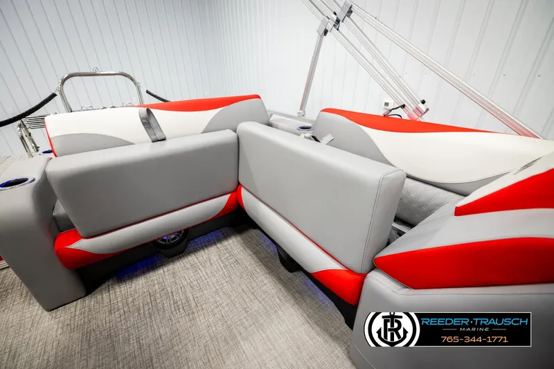 Slide: The Image of 2026 Avalon LSZ VRB boat interior with red and gray seating, Reeder Trausch Marine logo. - 22