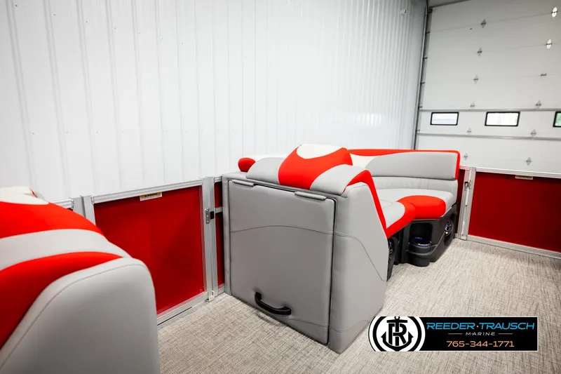Slide: The Image of 2026 Avalon LSZ VRB boat interior with red and gray seating in a garage setting. - 29