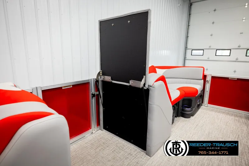 Slide: The Image of 2026 Avalon LSZ VRB boat interior with red and gray seating, Reeder-Trausch Marine logo. - 30