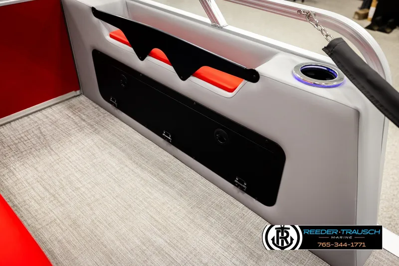 Slide: The Image of 2026 Avalon LSZ VRB boat interior with red accents and cup holder. - 31