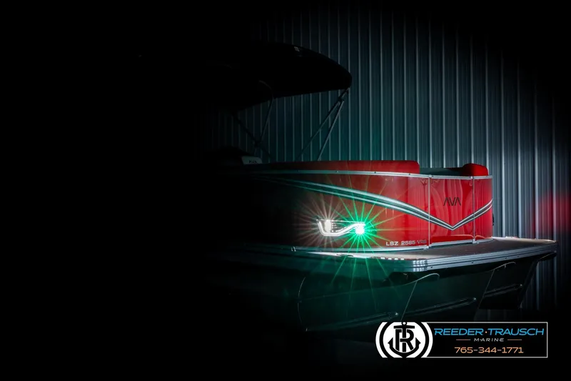 The Image of 2026 Avalon LSZ VRB pontoon boat with illuminated front light in a dimly lit setting. - 4