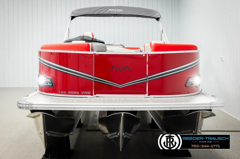 Slide: The Image of 2026 Avalon LSZ VRB pontoon boat, red exterior, displayed indoors at Reeder-Trausch Marine. - 8