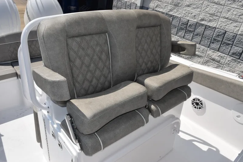 Slide: The Image of 2026 Sea Hunt Ultra 265 SE boat seating with gray upholstery and diamond stitching. - 11
