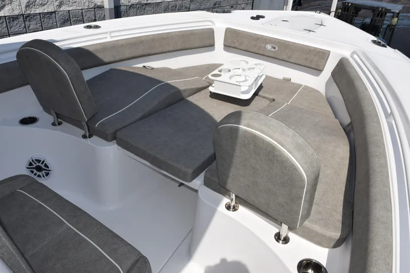 Slide: The Image of 2026 Sea Hunt Ultra 265 SE boat interior with gray cushioned seating and cup holders. - 12