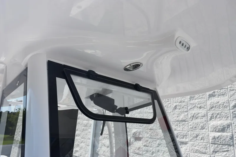 Slide: The Image of 2026 Sea Hunt Ultra 265 SE boat interior with window and ceiling details. - 14