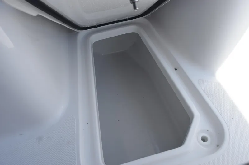 Slide: The Image of Storage compartment of 2026 Sea Hunt Ultra 265 SE boat, open and empty. - 15