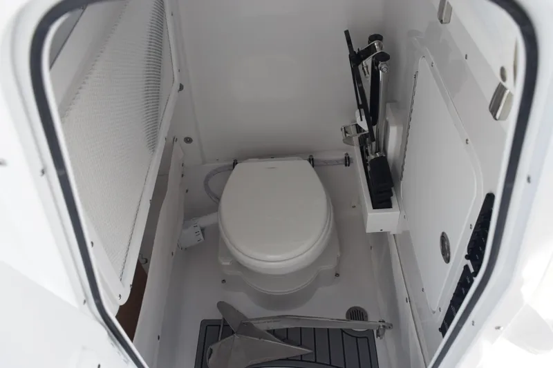 Slide: The Image of 2026 Sea Hunt Ultra 265 SE boat interior with compact marine toilet. - 17