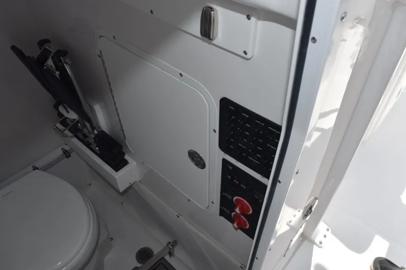 Slide: The Image of Interior of 2026 Sea Hunt Ultra 265 SE boat, featuring control panel and toilet. - 18