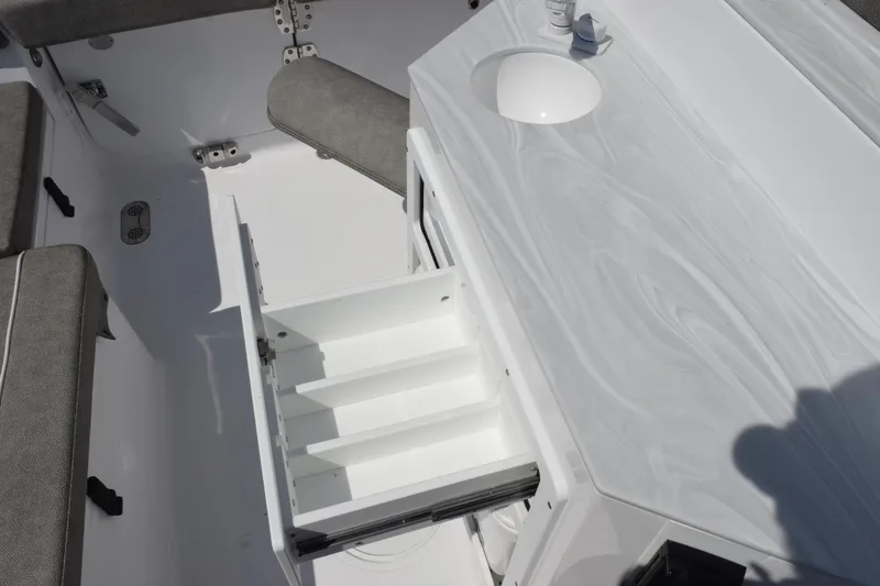 Slide: The Image of Interior of 2026 Sea Hunt Ultra 265 SE boat with open storage compartment. - 21