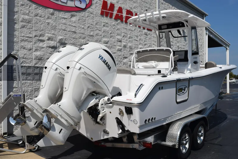 Slide: The Image of 2026 Sea Hunt Ultra 265 SE boat with dual Yamaha engines on a trailer. - 4