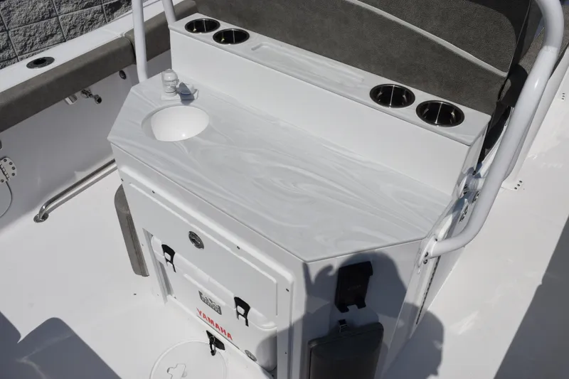 Slide: The Image of 2026 Sea Hunt Ultra 265 SE boat interior with sink and cup holders. - 7